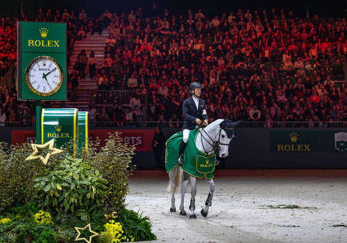 Kent Farrington (USA) stands alongside a Rolex clock after winning the Rolex Grand Prix with Greya