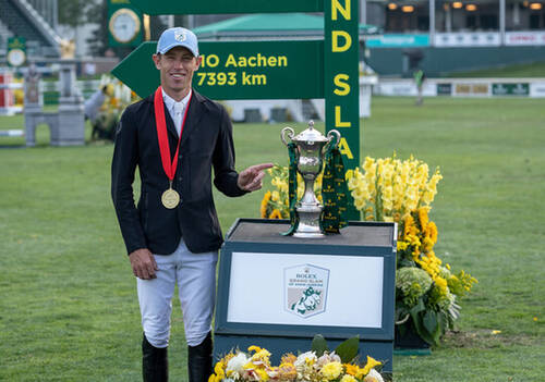 Scott Brash pointing to the Rolex Grand Slam Trophy he won 10 years ago - Rolex Grand Slam/Ashley Neuhof