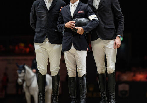 Kent Farrington (USA) celebrates on the podium after winning the Rolex Grand Prix with Greya as he stands alongside second place finisher Shane Sweetnam (IRL) and third place finisher Thibeau Spits (BEL)