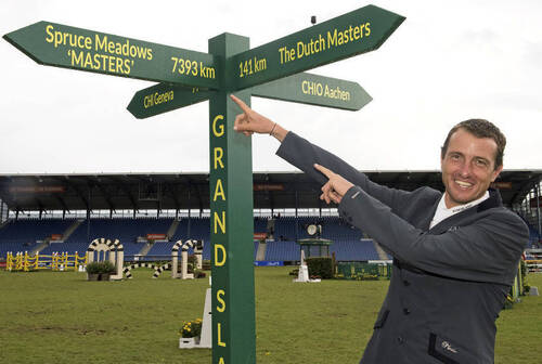 Gregory Whatelet with the Rolex Grand Slam signpost (picture: Rolex Grand Slam of Show Jumping/Kit Houghton)